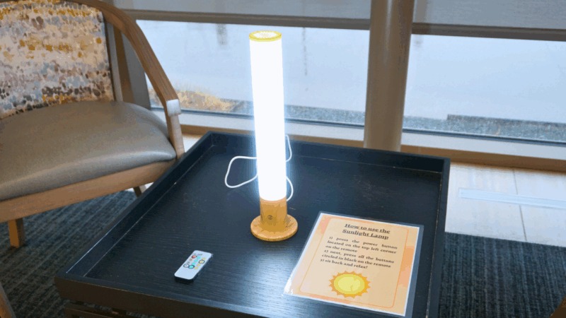 Bright lamp on a table with a remote and instructions.