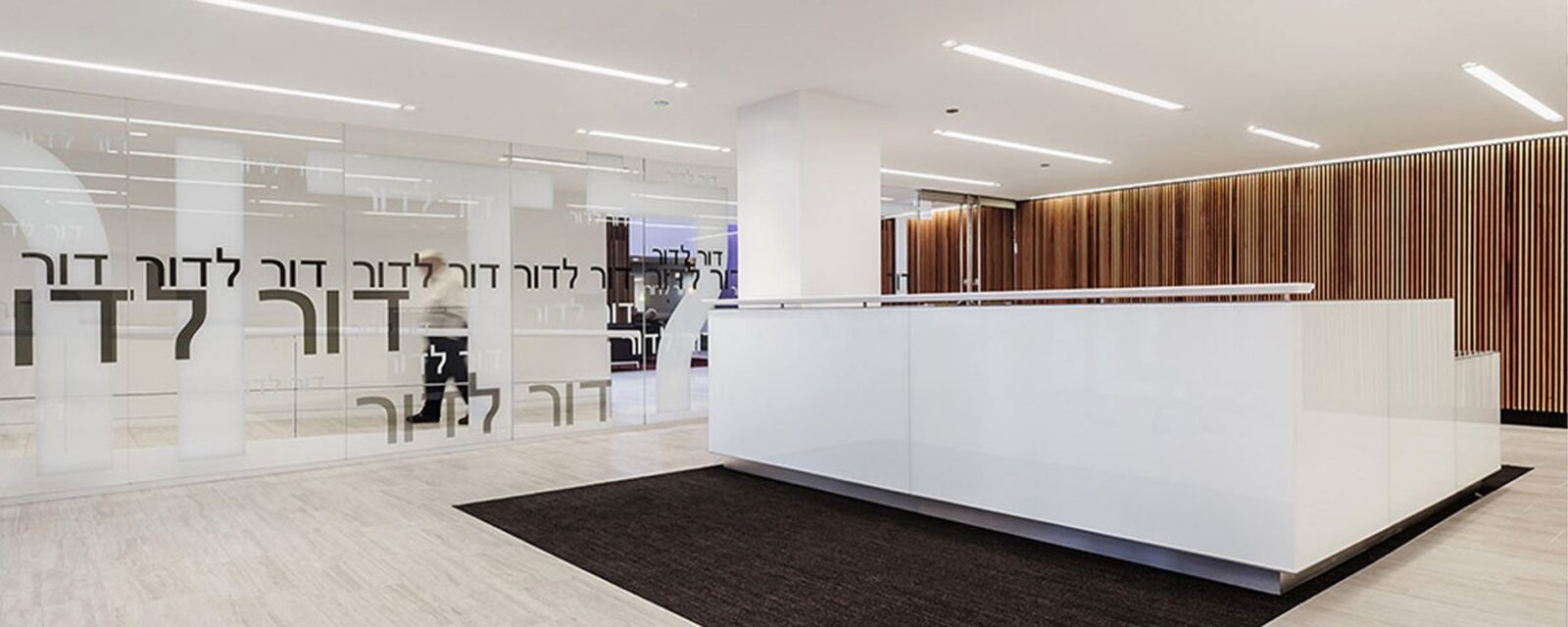 Modern reception area with glass walls and sleek design.