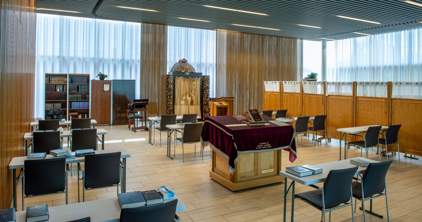 Modern interior of a worship space with seating and books.